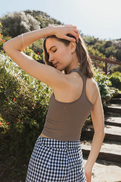 Model wearing a brown ultra comfort racerback brami paired with a gingham skirt outdoors