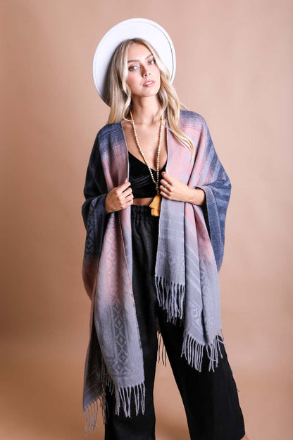 Leto Collection western serape tassel shawl in pastel colors, styled with a hat and layered jewelry